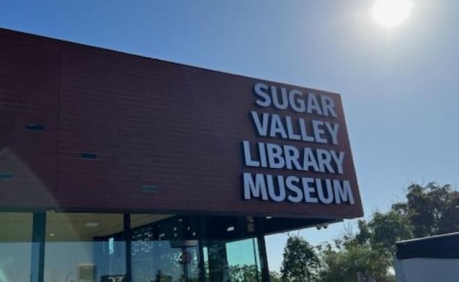 cropped-images sugar-valley-library-museum-outdoor-signage-112-101-482-297-1681693934